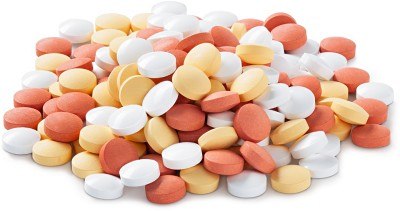 A pile of multicolored tablets, including white, yellow, and red pills, isolated on a white background. A pile of multicolored tablets, including white, yellow, and red pills, isolated on a white background.