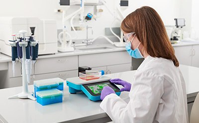 Millicell® DCI Digital Cell Imager for cell culture analysis Scientist monitoring cells using the Millicell<sup>®</sup> DCI