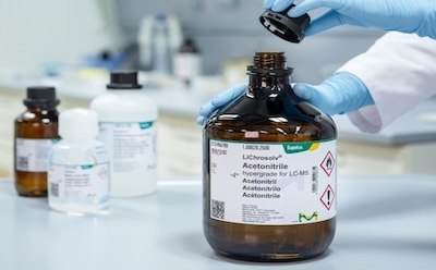 A laboratory setting where a researcher is handling a bottle of LiChrosolv® Acetonitrile A laboratory setting where a researcher is handling a bottle of LiChrosolv® Acetonitrile