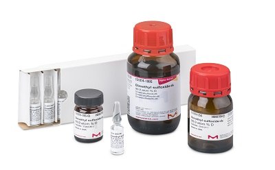 NMR Solvents A collection of NMR solvents displayed on a white surface, including two large brown bottles with red caps, a small vial, and a set of glass ampoules in a white box, all labeled for precise spectroscopic analysis.