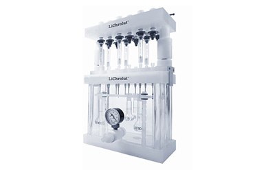 Lichrolut Extraction A laboratory apparatus called LiChrolut, which is used for solid-phase extraction. The device has multiple vertical columns and tubes, along with a pressure gauge, and is designed for processing multiple samples simultaneously.