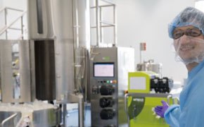 FBS The image depicts a person in a laboratory setting, engaged with advanced equipment and machinery.