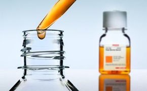 Cell Culture Supplements & Reagents Serum is added to a bottle via dropper