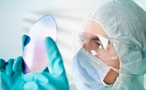 Substrates & Prefab Electronic Components Scientist wearing protective clothing inspecting prefabricated pre-patterned electronic device substrate