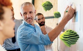 <p>Webinar: Does your SVP Process Assure Sterile Drug Product?</p>
 A group of people, one of whom is writing on a whiteboard, while others observe, with colorful geometric shapes displayed in the background.