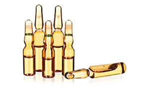 The image show a collection of five small glass ampoules containing a golden-yellow liquid.  The image show a collection of five small glass ampoules containing a golden-yellow liquid.