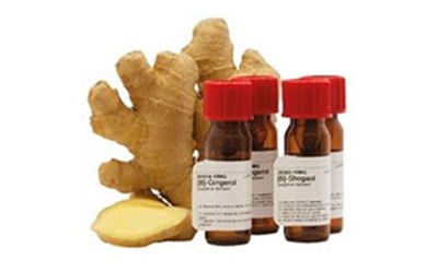 Phytochemical Reference Standards This image consists of few pieces of ginger and 4 small bottles with red cap containing some form of chemical.