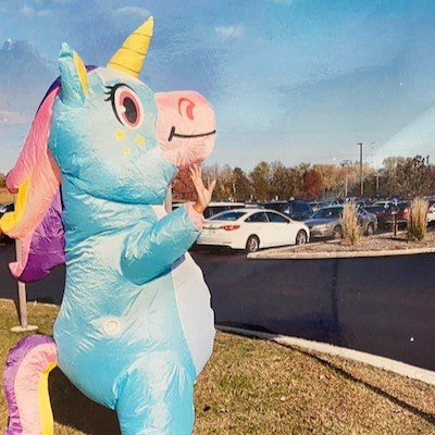 Chevon Adams A blow-up unicorn — with Chevon Adams underneath — waves to the camera in the parking lot outside the Milwaukee site.