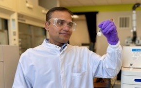 Karwa lab tile Karwa stands in lab next to an analytical instrument that helps determine the purity of mRNA.