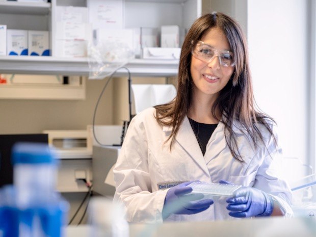 Samaridou lab Eleni Samaridou stands in the lab wearing a lab coat, gloves and glasses.