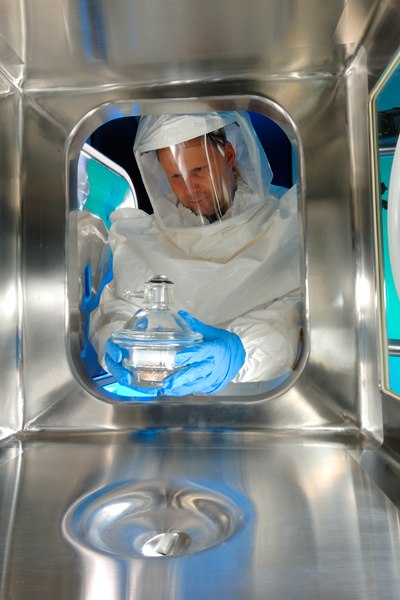 Team member handling highly active compound at contract manufacturing facility Team member handling highly active compound at contract manufacturing facility