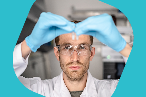Integrated mRNA-LNP CDMO offering Operator analyzing a vial of mRNA encapsulated in a Lipid Nanoparticle