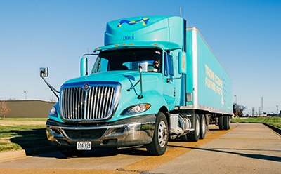 Providing a robust supply chain is at every stage of your manufacturing journey Company truck on a road, delivering materials to customers.