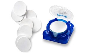 Pile of Millipore filter membranes with stack of filters in plastic container. Pile of Millipore filter membranes with stack of filters in plastic container.