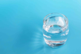 Drinking water Glass of drinking water on a blue background