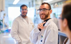 Activate Savings  Professionals smiling in lab coats in a lab setting