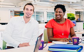 New Lab Start-Up — A Partnership Program MilliporeSigma representative standing next to a customer working in a lab.